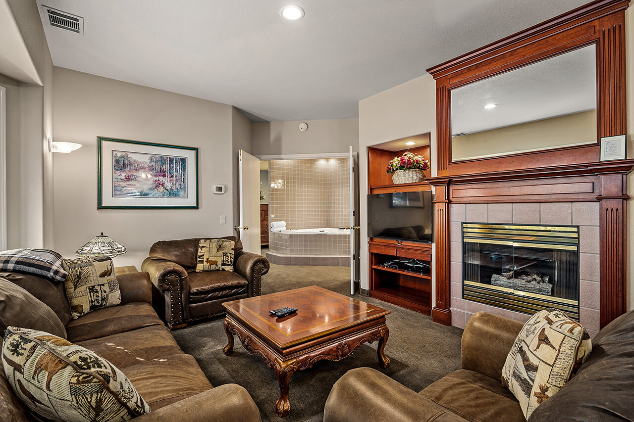 Living room photo showing fireplace and comfortable couch and chairs