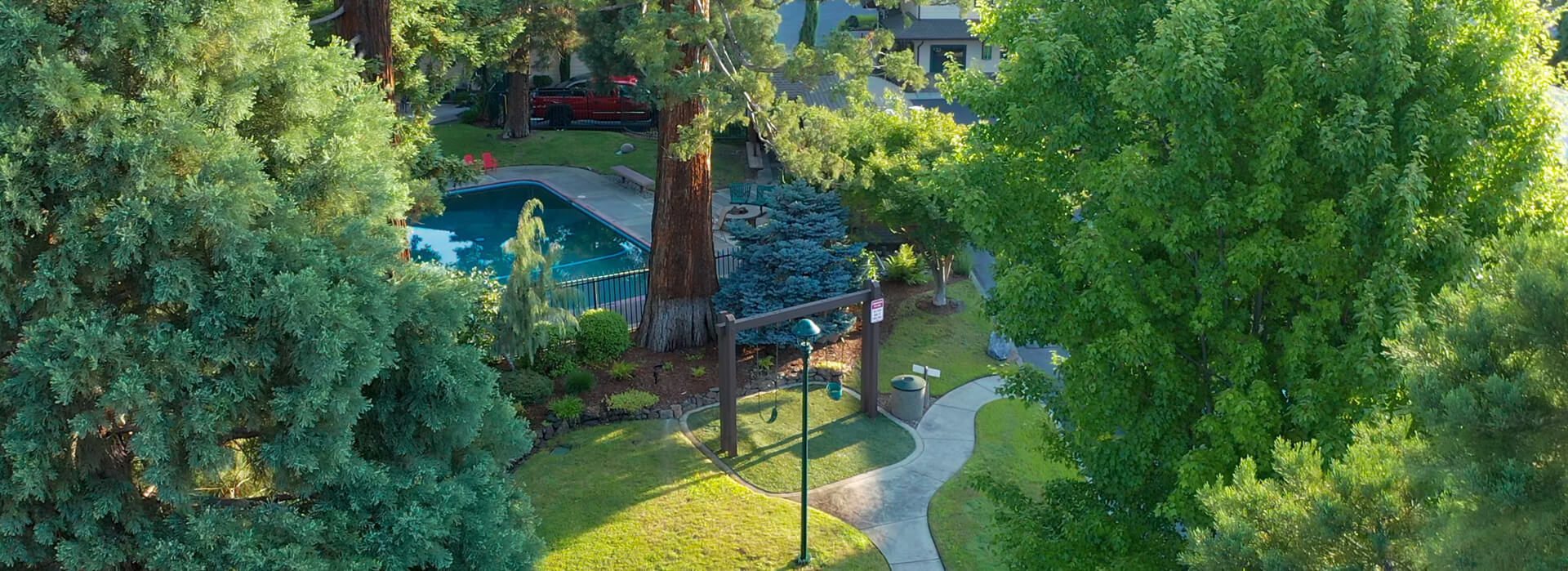 view of the pool and the beautifully landscaped grounds at the Redwood Hyperion hotel in Grants Pass oregon