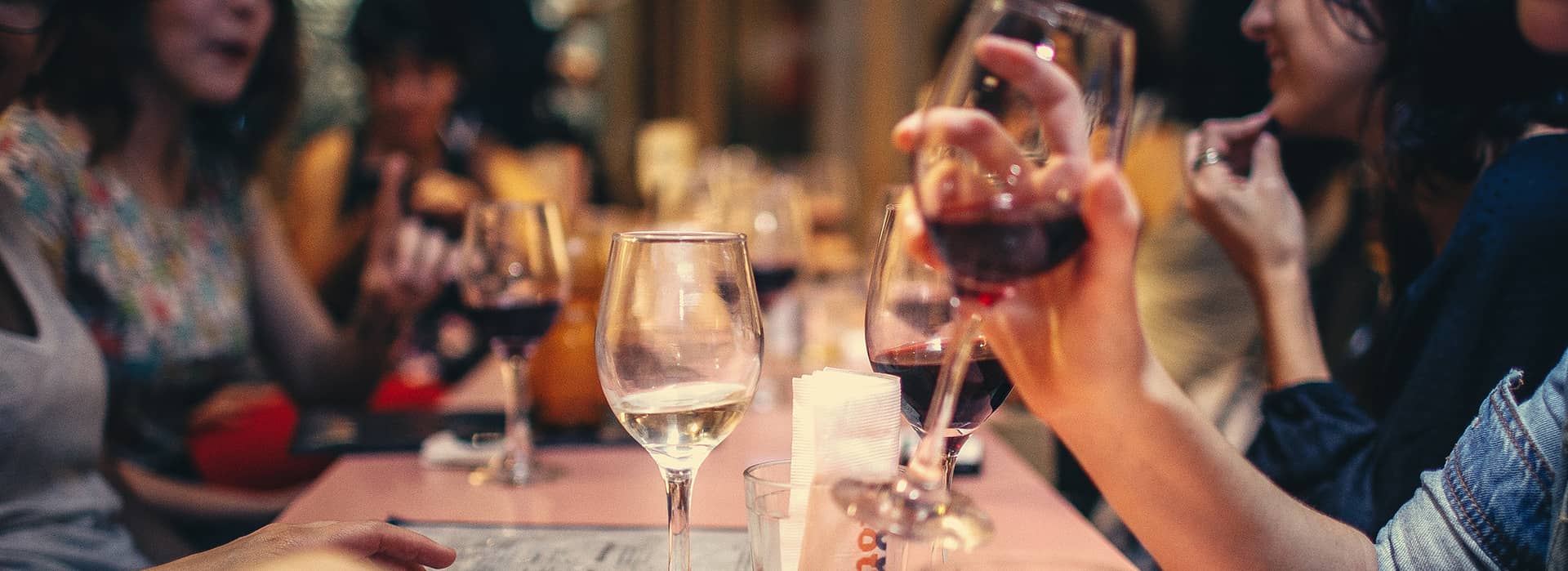 a photo of people around a table drinking wine